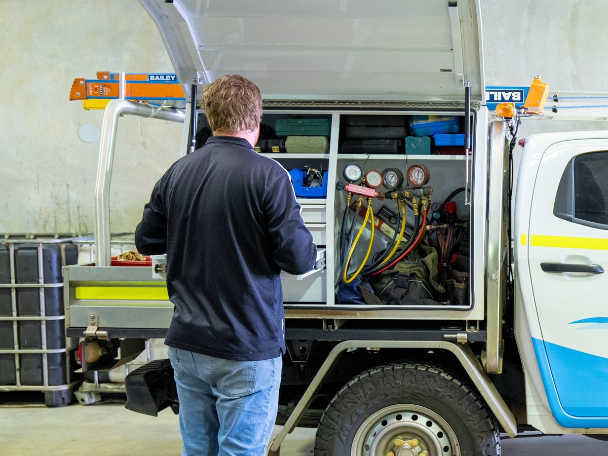 Pristine Cooling technician at the service body with gauges and hoses, Kalgoorlie