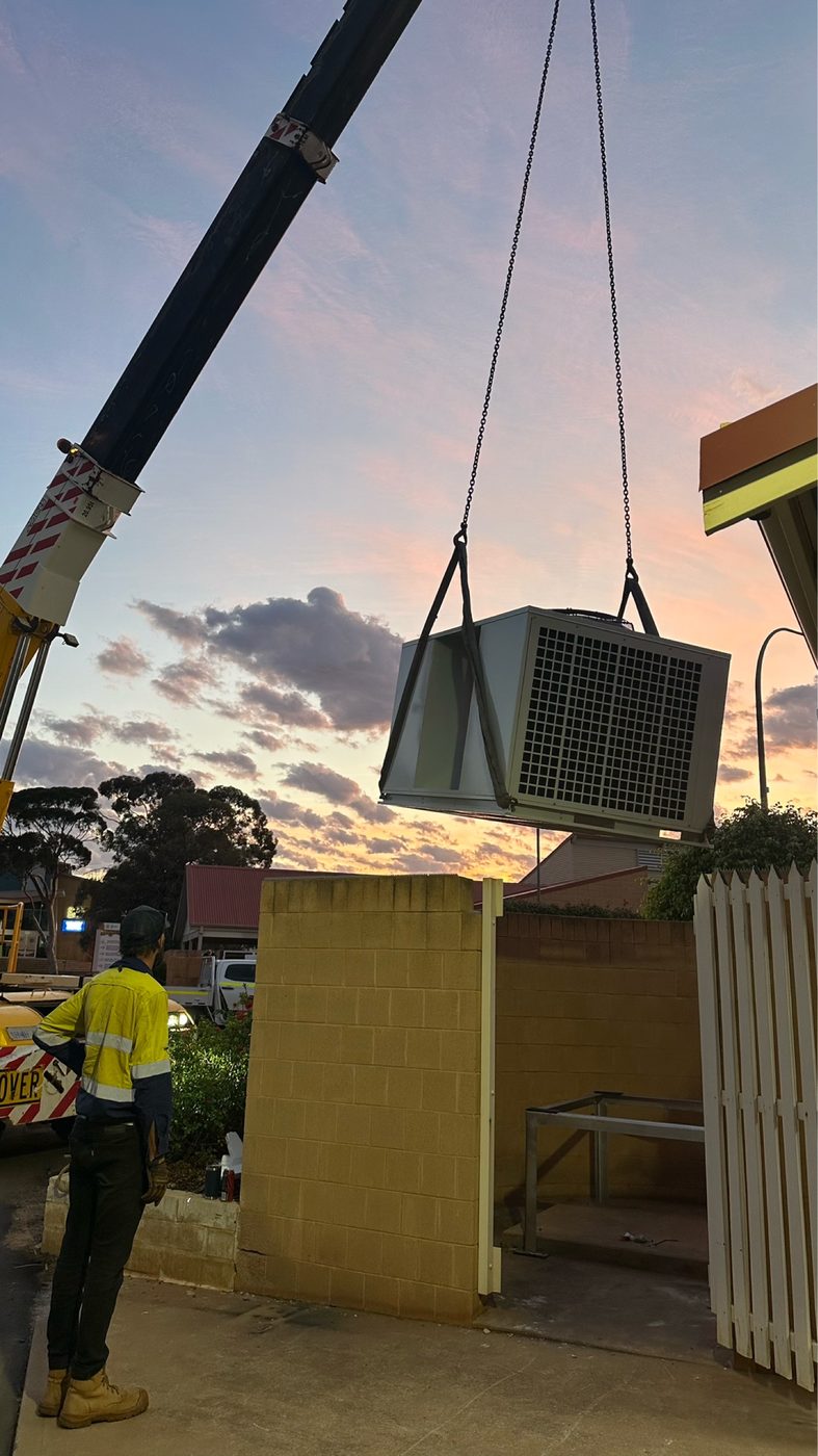 Packaged air conditioning unit craned into place at Central Regional TAFE Kalgoorlie